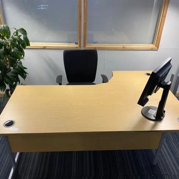 Large L-shaped brown desk with corner storage