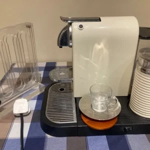 Nespresso coffee machine with frother and pod rack