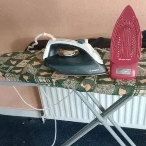 2 irons and iron board with covers