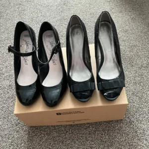 Two pairs of black patent heels