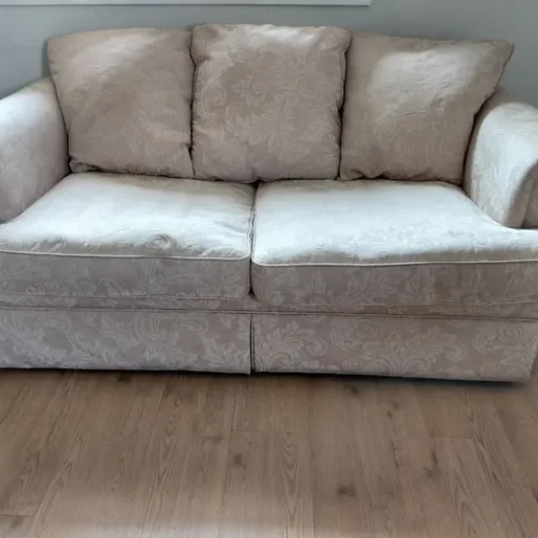 Beige sofa with three large cushions