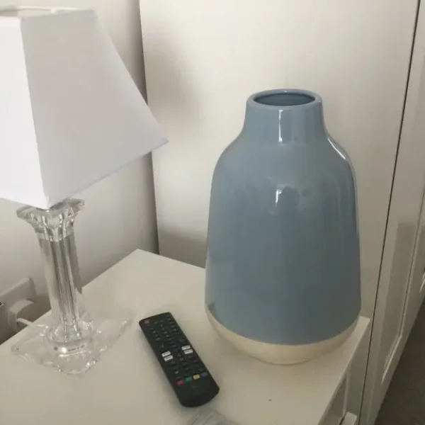 IKEA bedside lights, feather cushions, garden duvet cover and vases