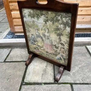 Old oak firescreen with glass embroidery of two men proposing