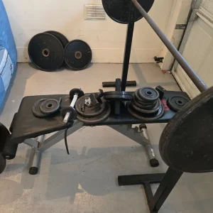 Adjustable weight stands with barbell plates and bench - Image 2