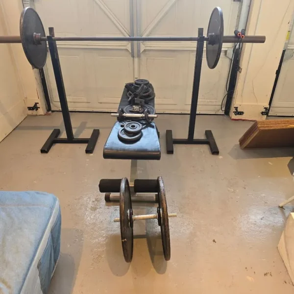 Adjustable weight stands with barbell plates and bench