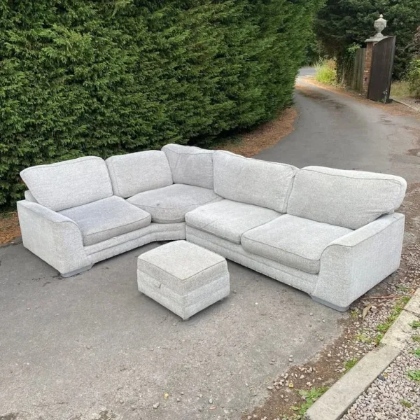 Corner sofa with footstool