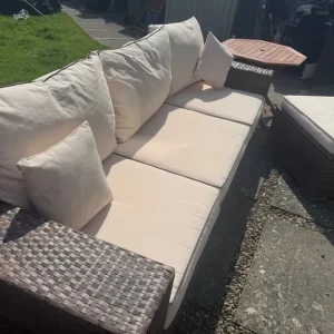 Large rattan sofa with footstool and storage table - Image 3