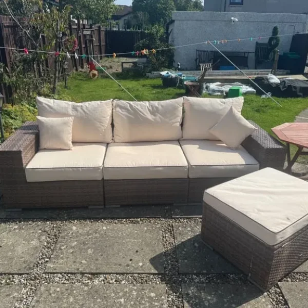 Large rattan sofa with footstool and storage table
