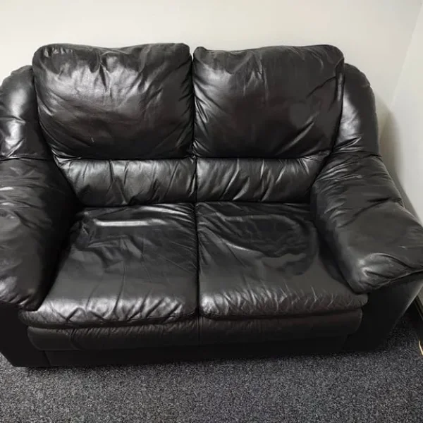 Black leather two seater sofa