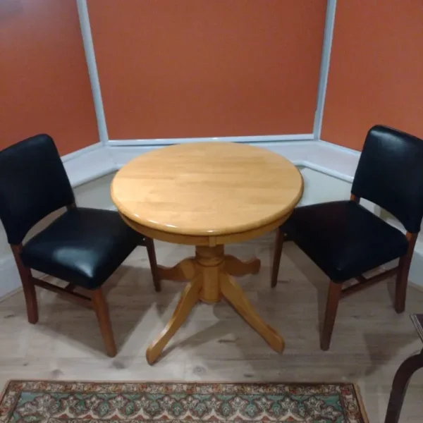 Round wooden dining table with 2 chairs