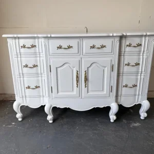 White French solid wood carved dresser with 8 drawers and gold fittings