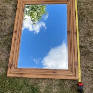 Bevelled mirror in stained pine frame