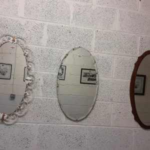 Vintage oval mirrors, one with white metal frame