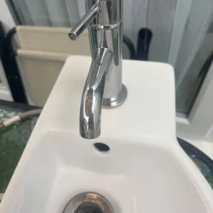 Cloakroom sink with chrome tap and hoses - Image 3