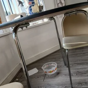 Black round dining table and 3 triangular chairs