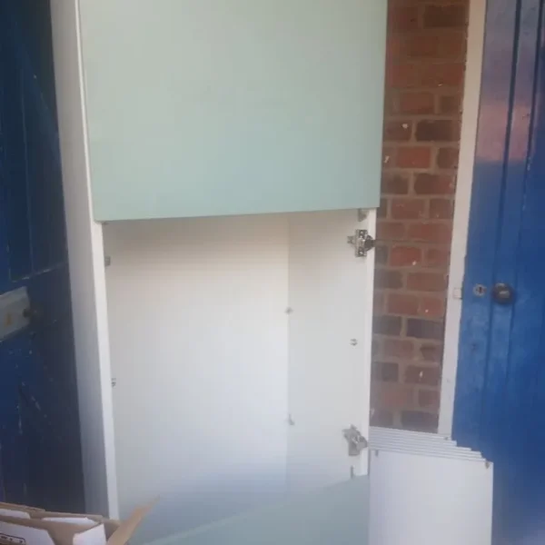 A two-piece tool Green cupboard comes with shelves and Glass and has glass doors