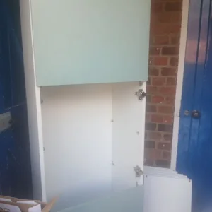 A two-piece tool Green cupboard comes with shelves and Glass and has glass doors