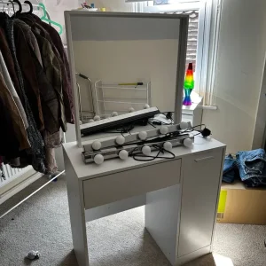 Vanity table, mirror and two lights