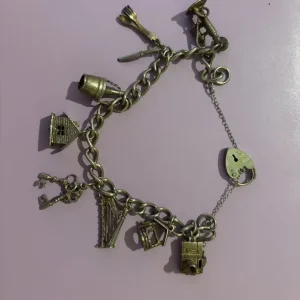 Vintage silver hallmark charm bracelet with 8 charms, 7" London 1979