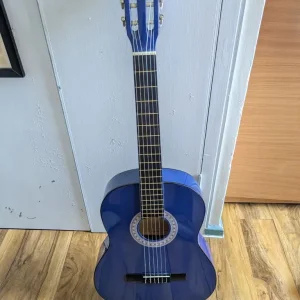 Blue full-size classical guitar with bag and strings