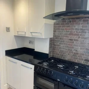 Full kitchen with granite worktops and integrated dishwasher - Image 3