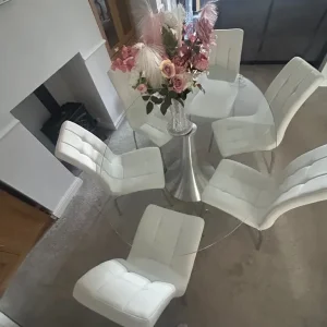 Glass oval table and 6 ivory faux leather chairs
