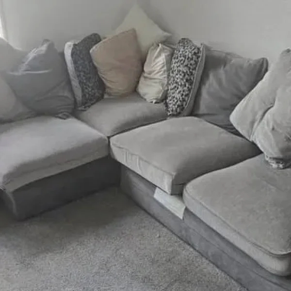 Grey corner sofa with matching footstool