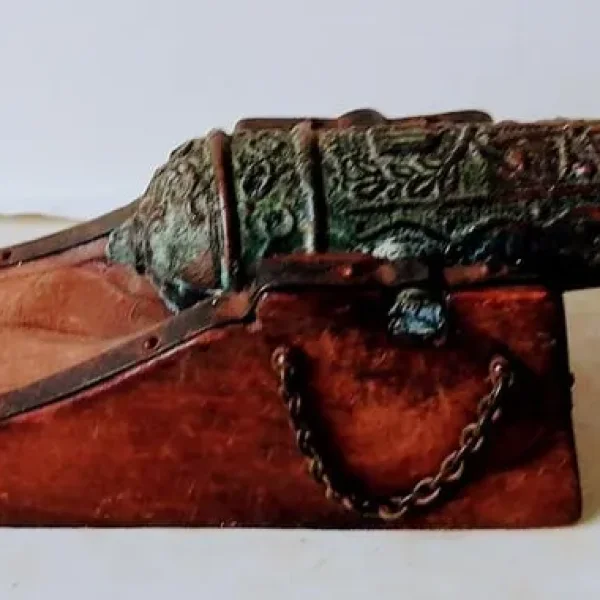 Small brass cannon on wood base