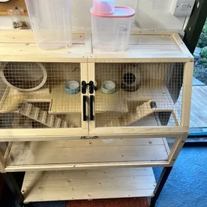 Wooden hamster cage with shelf and wheels