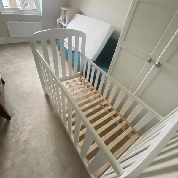 Wooden cot bed with mattress from John Lewis