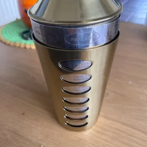 Gold cocktail shaker with recipe cards