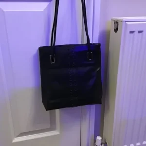 Black shoulder bag with chrome trim