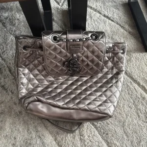 GUESS Miriam Silver Quilted Backpack.
