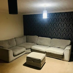 Corner sofa with footstool