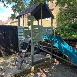 Wooden play house with slide