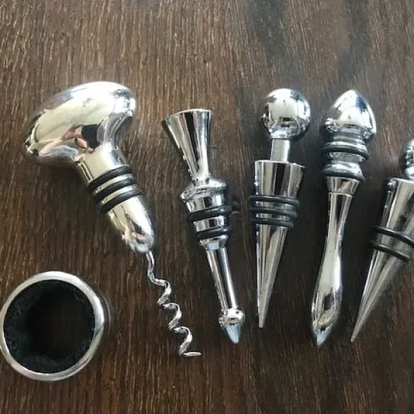 A Set Of Metal Bottle Stoppers, Silver Plated Corkscrew and Drip Ring