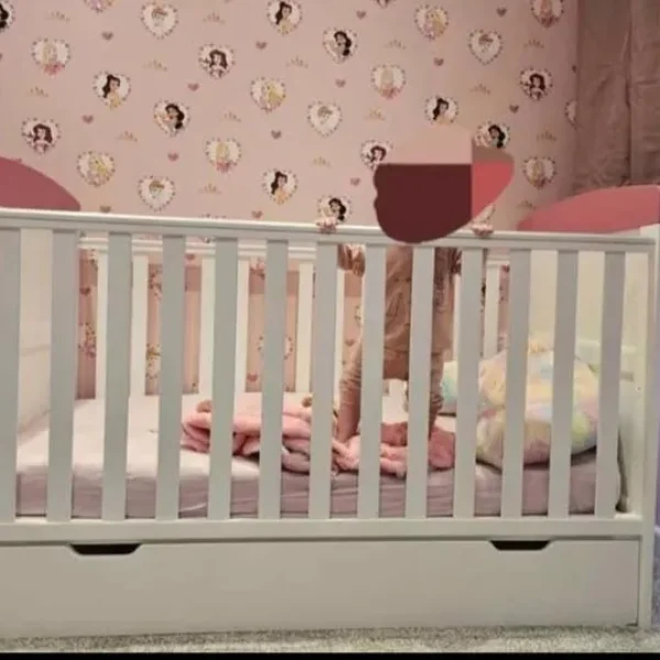 Cot bed with drawer.