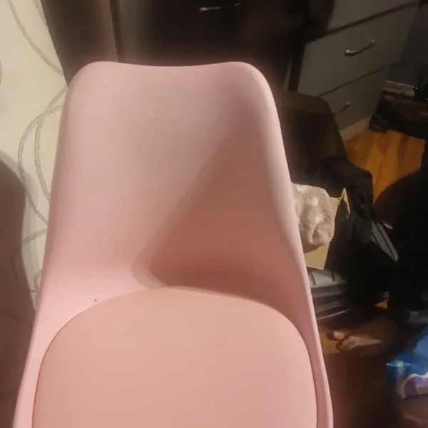 A set of of three pink and wooden legged chairs