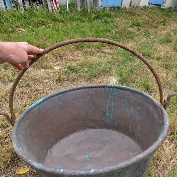 A very large antique copper cauldron.