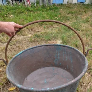 A very large antique copper cauldron.