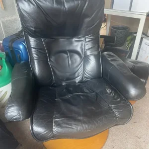 Black leather recliner and matching footstool