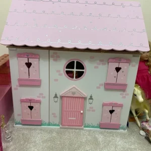 Girls wooden pink and cream dolls house