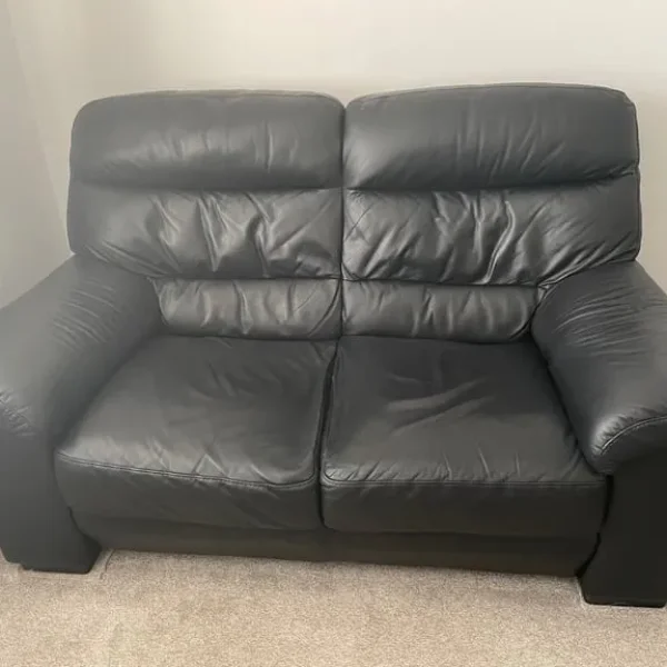 Black leather 2 seater sofa x2 with matching footstool