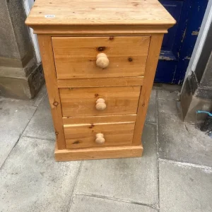 Solid pine , tall narrow chest of drawers .
