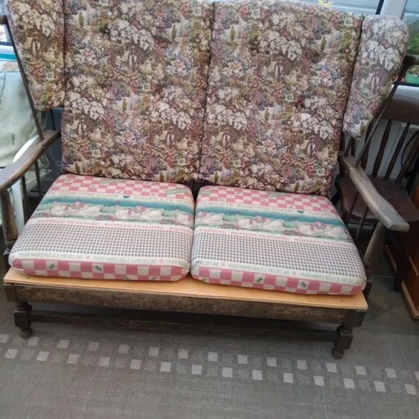 Two seater settee in medium oak .
