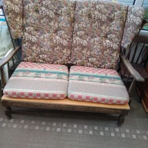 Two seater settee in medium oak .
