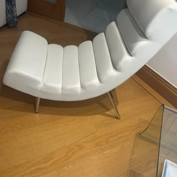 Two white easy chairs in faux leather