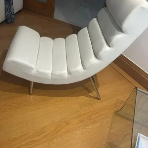 Two white easy chairs in faux leather