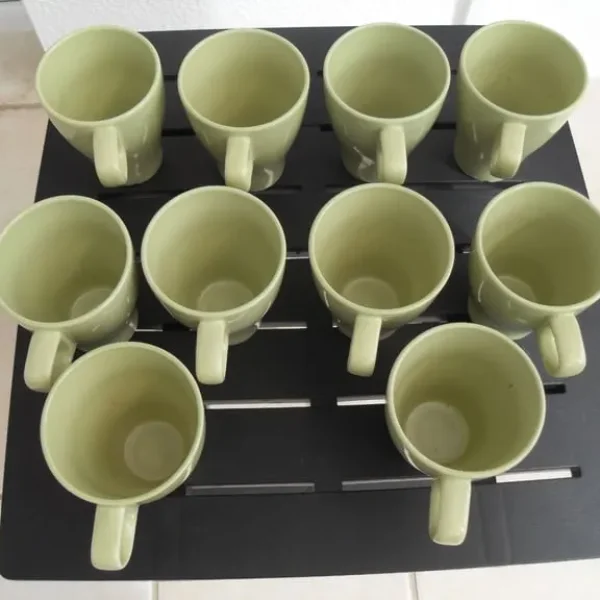 Set of 10 green ceramic Ikea mugs.
