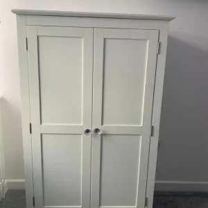 Double door white wood wardrobe with hanging rail